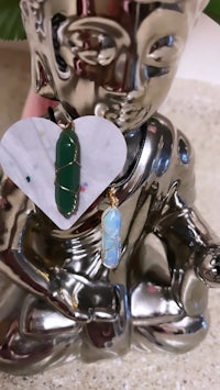 a buddha sitting on a silver plate